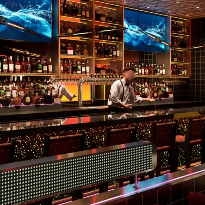 Bartender at a well-stocked bar with screens at Hungry Bowl, a Buffet Restaurant in Bowie