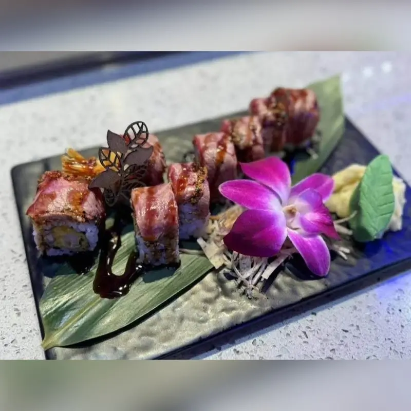 Delicious surf turf roll with an orchid garnish at Hungry Bowl, a Buffet Restaurant in Bowie